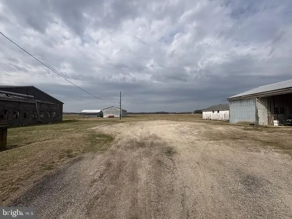 a view of a house with a yard and car parked