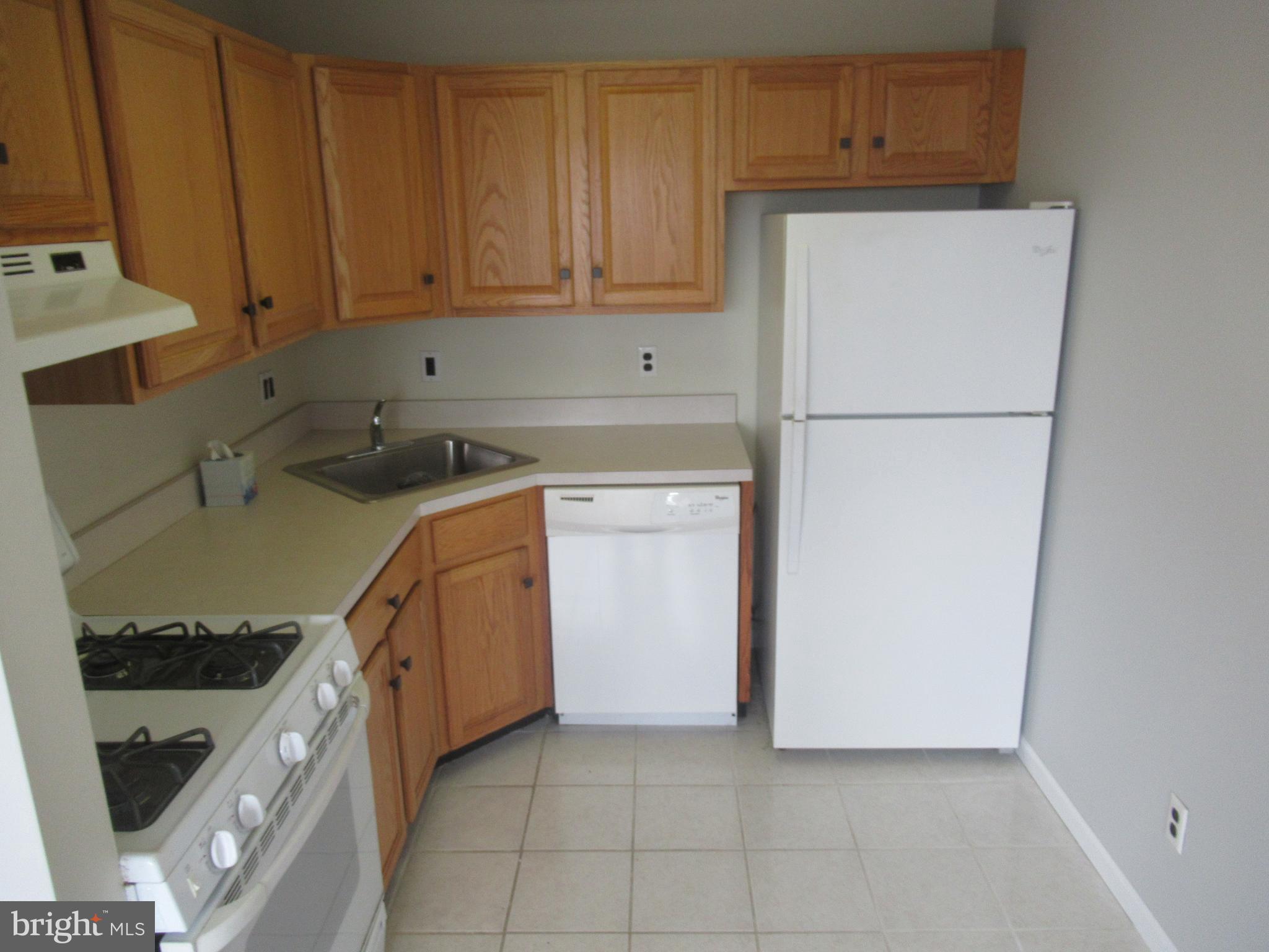 436 Coates Street Bridgeport, PA 19405 - Photo 5 of 20 a kitchen with a refrigerator sink stove and cabinets