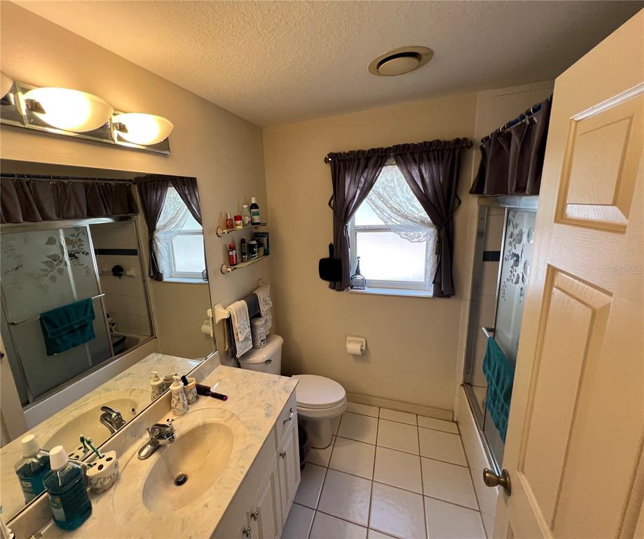 1995 East Newhaven Street Inverness, FL 34453 - Photo 23 of 48 a bathroom with a sink a toilet and mirror