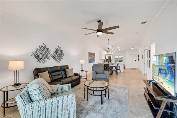 a living room with furniture a lamp and a chandelier