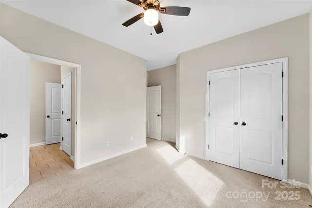 a view of a livingroom with a ceiling fan and entryway