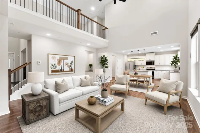 a living room with furniture and a view of kitchen