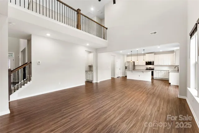 a view of a living room with wooden floor
