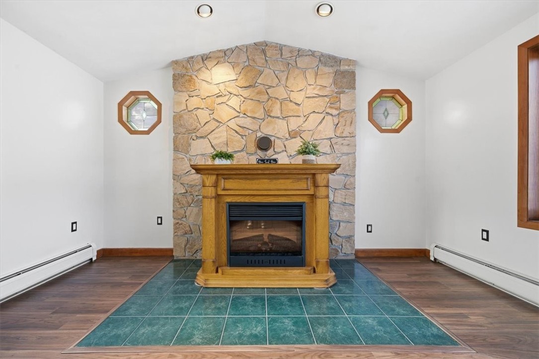 8 Meadow Lane Coventry, RI 02816 - Photo 7 of 45 The Great Room features a stone hearth centerpiece (ready for a wood stove - ust move that portable fireplace) and stained-glass accent windows.
