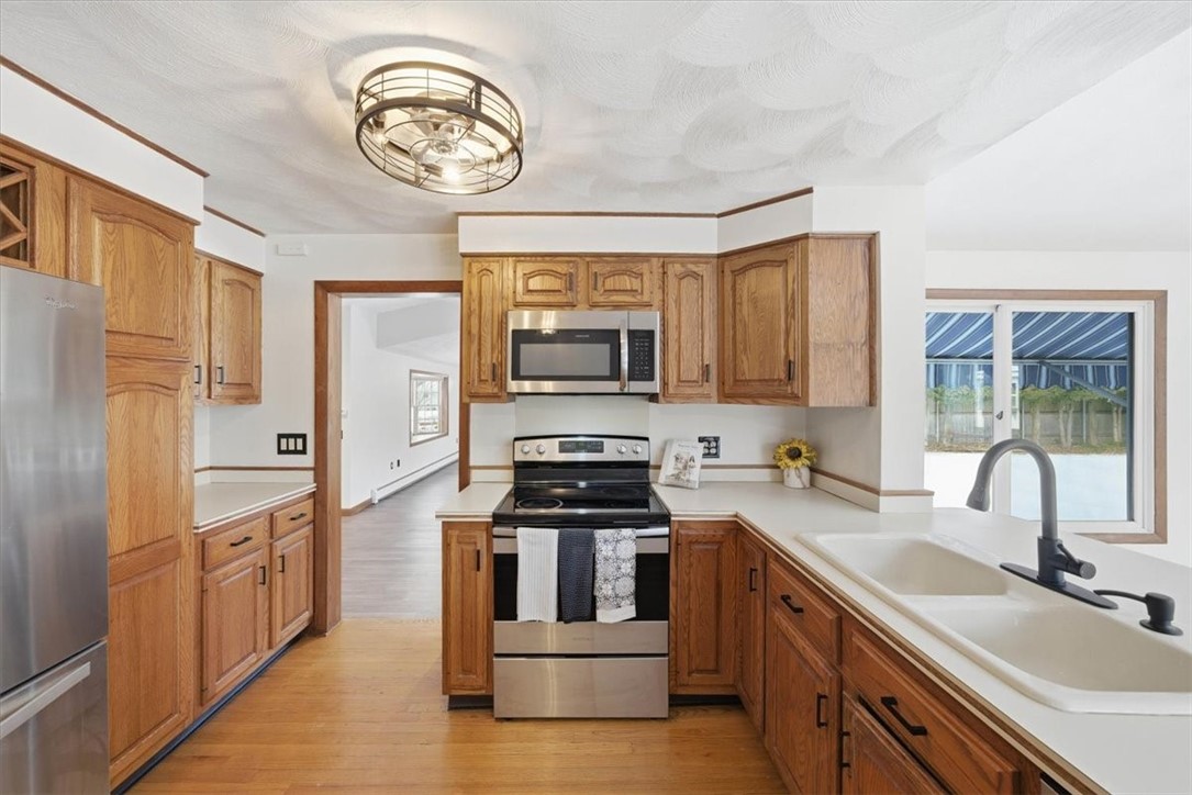 8 Meadow Lane Coventry, RI 02816 - Photo 10 of 45 The large eat-in kitchen features newer stainless appliances, solid wood cabinetry, abundant counter space, a breakfast bar for four, built-in desk, and room for a table