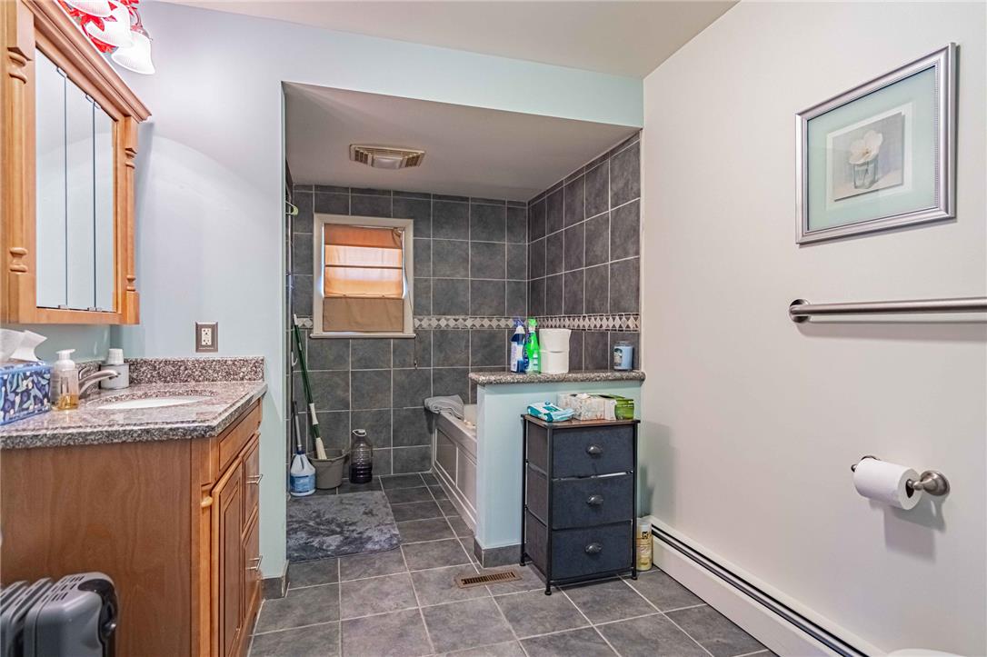 579 Cherry Road Northampton, PA 18067 - Photo 30 of 57 Granite counters complement the inviting tub area, creating a practical and appealing washroom.