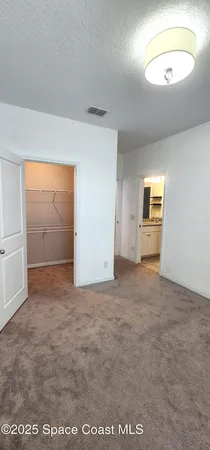 an empty room with a empty space and windows