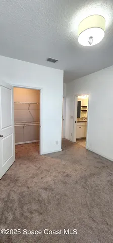 an empty room with a empty space and windows