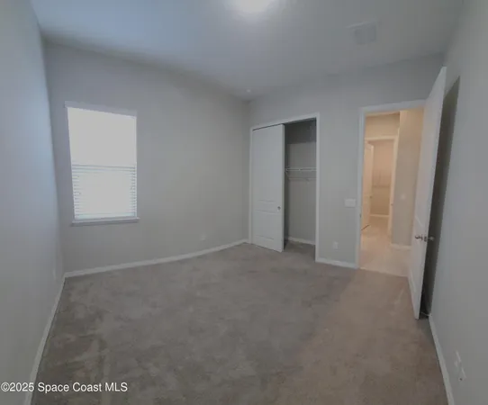 a view of an empty room and a window
