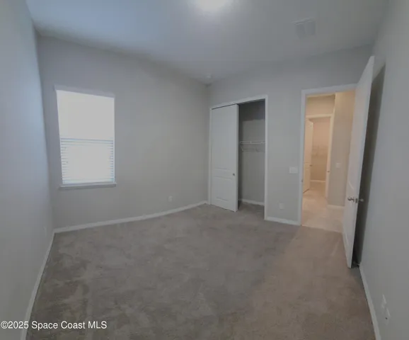a view of an empty room and a window