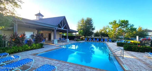 a view of a house with swimming pool patio and garden