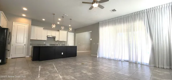 a kitchen with a refrigerator and a sink