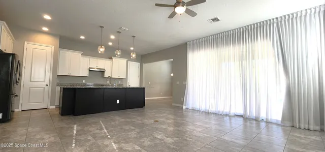 a kitchen with a refrigerator and a sink