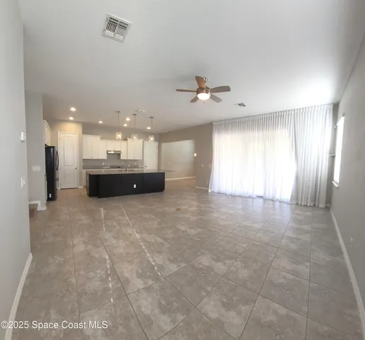 a view of a kitchen with a sink and a large window