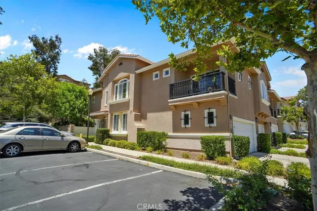 a couple of cars parked in front of a house