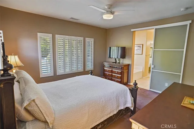 a bedroom with a bed and a television