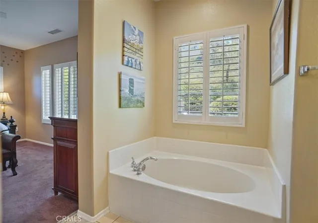 a white bath tub sitting next to a window