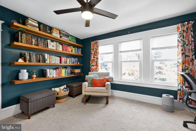 a reading room with furniture and a book shelf