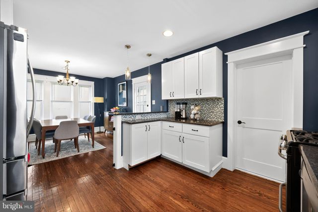 a kitchen with sink cabinets and wooden floor