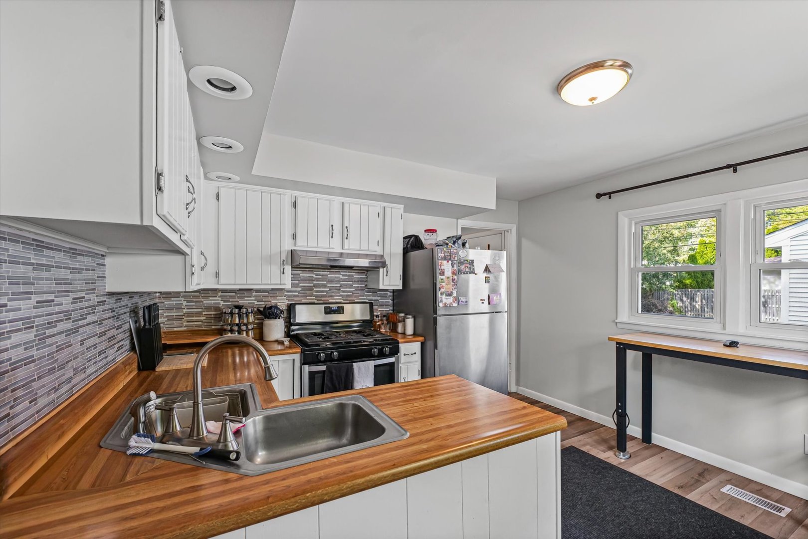 1608 Sheridan Road Champaign, IL 61821 - Photo 11 of 29 a kitchen with a stove a refrigerator and a stove top oven