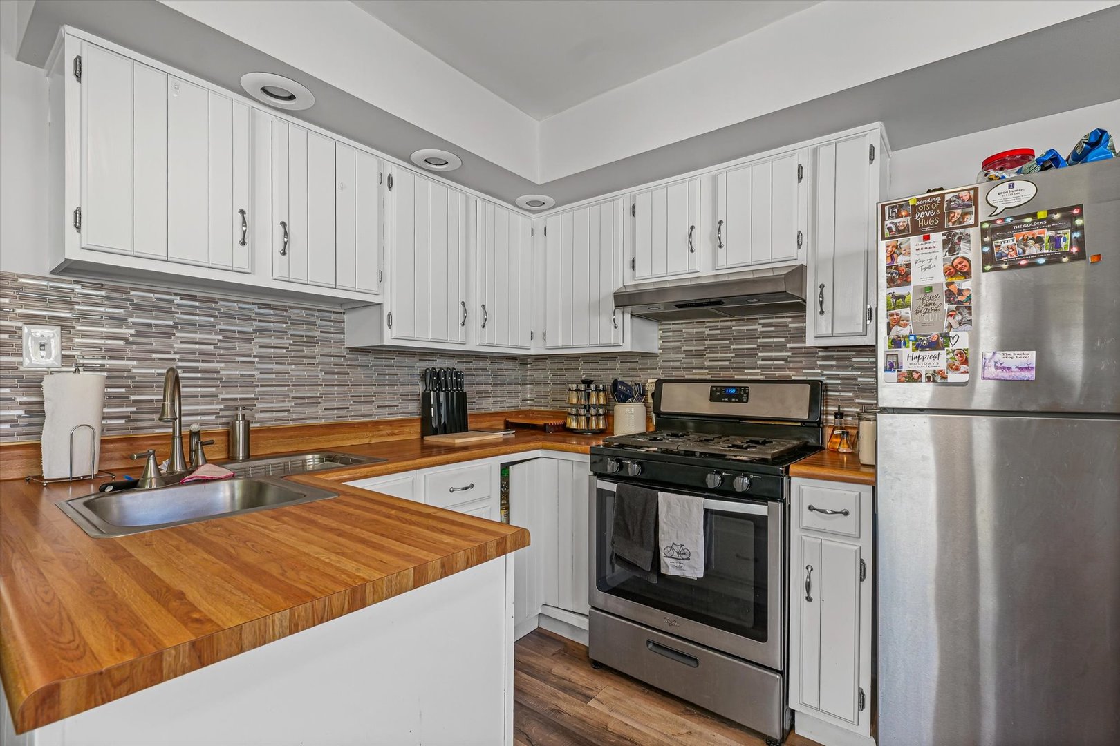 1608 Sheridan Road Champaign, IL 61821 - Photo 12 of 29 a kitchen with stainless steel appliances granite countertop a stove a sink and a white cabinets