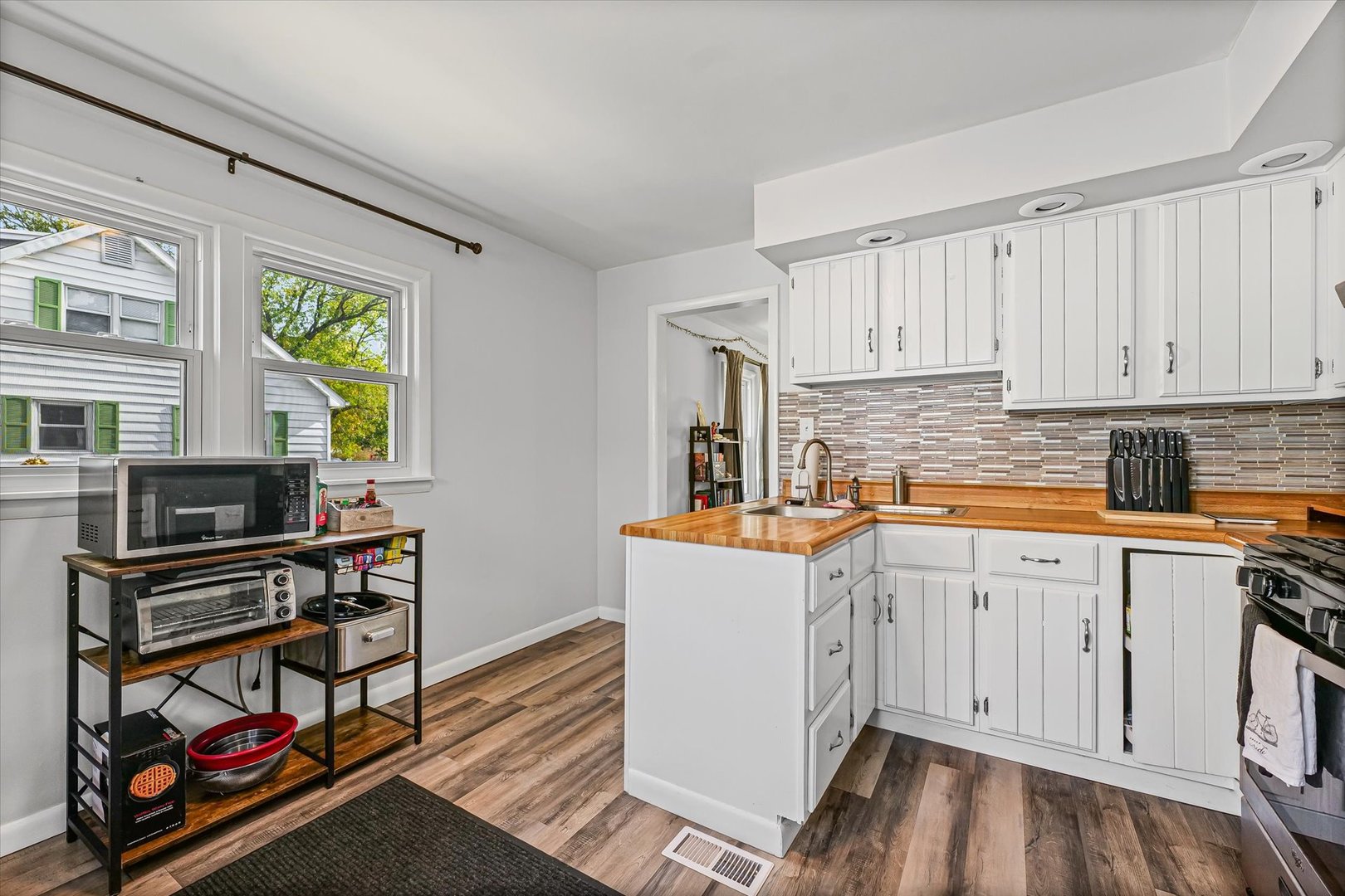 1608 Sheridan Road Champaign, IL 61821 - Photo 14 of 29 a kitchen with stainless steel appliances a stove a sink and a refrigerator
