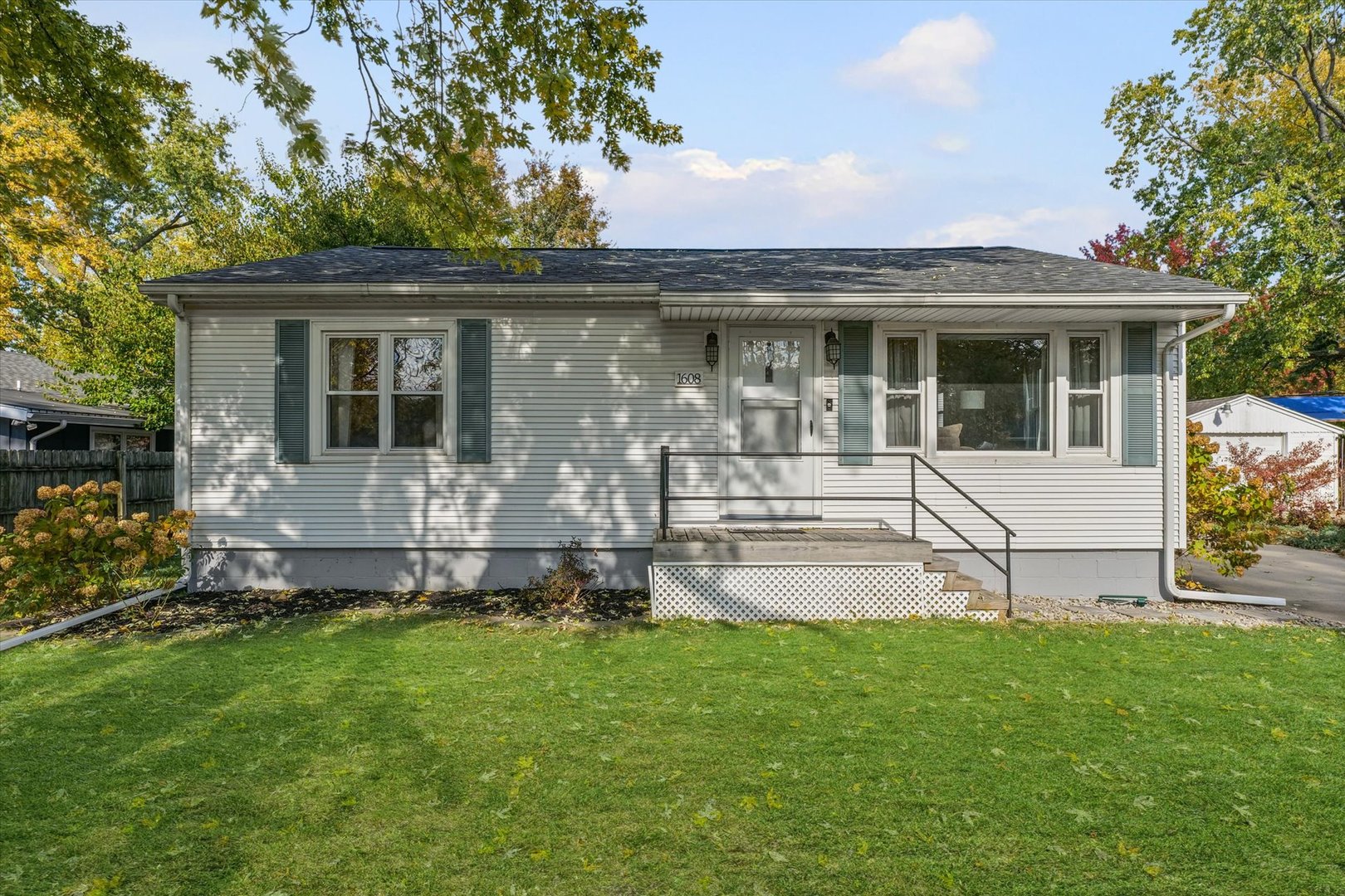 1608 Sheridan Road Champaign, IL 61821 - Photo 2 of 29 a front view of a house with a garden and yard