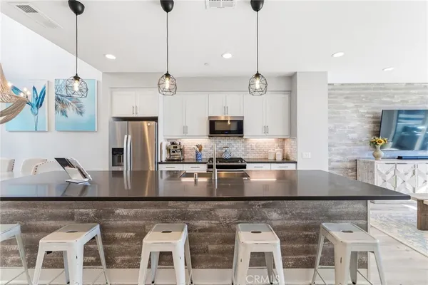 a kitchen with stainless steel appliances granite countertop a kitchen island a stove and a granite counter tops