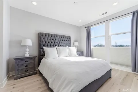a bedroom with a bed and a night stand