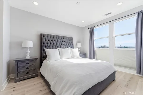 a bedroom with a bed and a night stand
