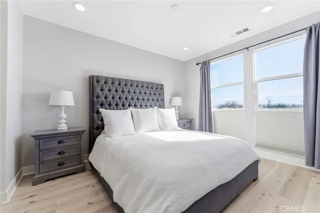 a bedroom with a bed and a night stand