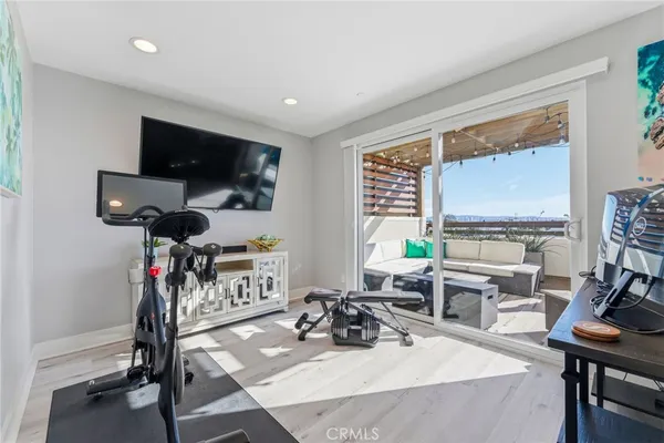 a view of a workspace with furniture and a gym cycle