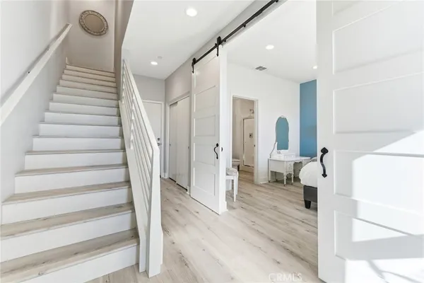 a view of entryway with furniture and wooden floor