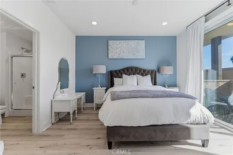 a bedroom with a bed a mirror and a table