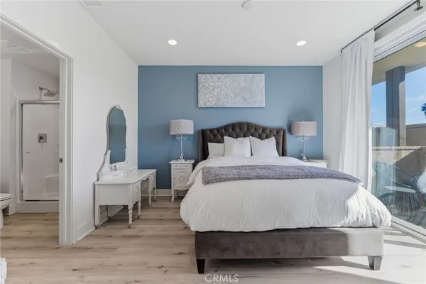 a bedroom with a bed a mirror and a table