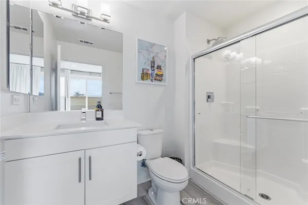 a bathroom with a sink a toilet and shower