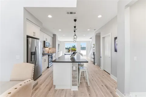a view of a dining room with furniture wooden floor and a chandelier