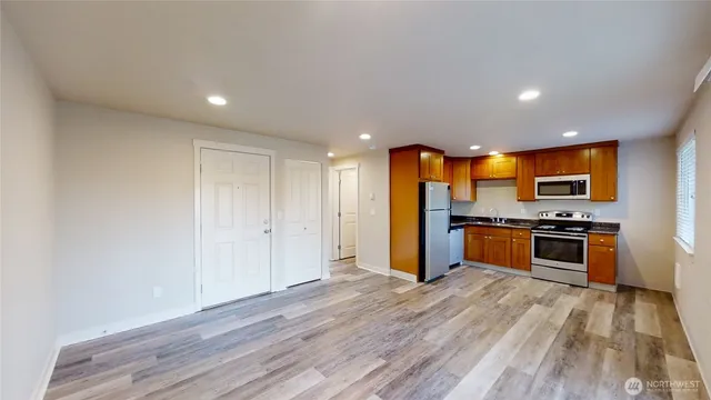 a kitchen with stainless steel appliances a refrigerator and a stove top oven