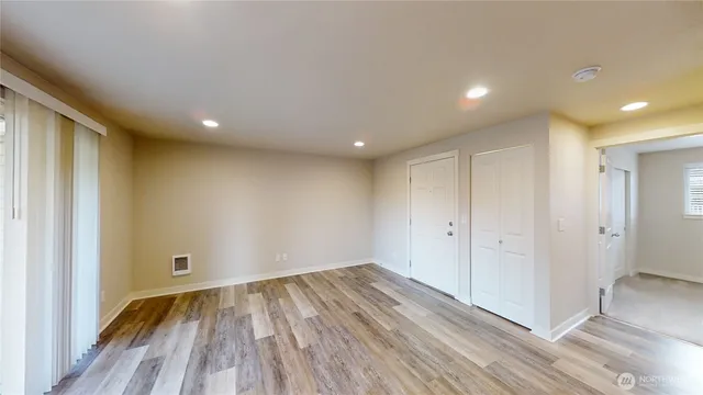 a view of a room with wooden floor