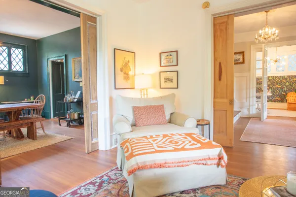 a view of a bedroom with wooden floor and windows