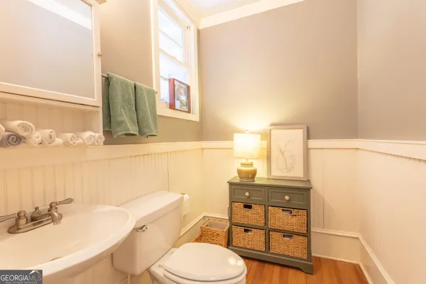 a kitchen with stainless steel appliances wooden cabinets table chairs and a window