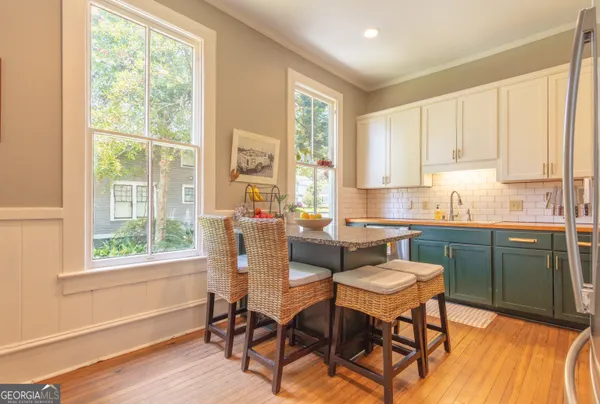 a kitchen with a sink stove and cabinets