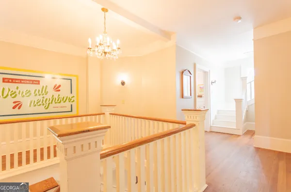 a view of a hallway with wooden floor and entryway