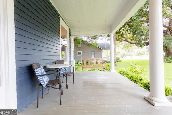 a view of a patio with table and chairs and potted plants