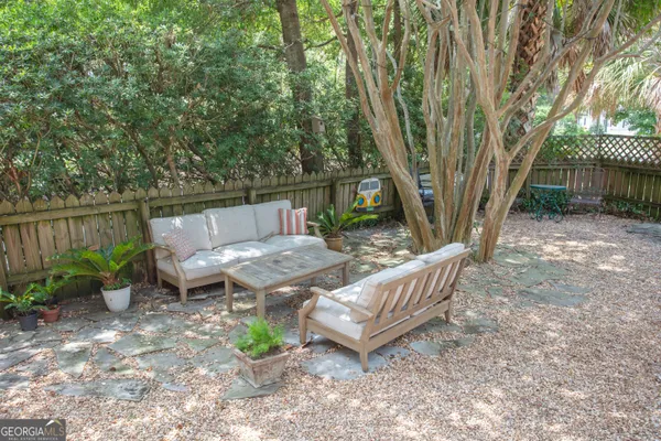 a view of a backyard with sitting area and furniture