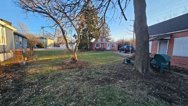 a view of a backyard with large trees