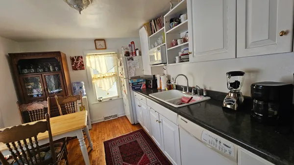 a kitchen with stainless steel appliances granite countertop a stove and a refrigerator