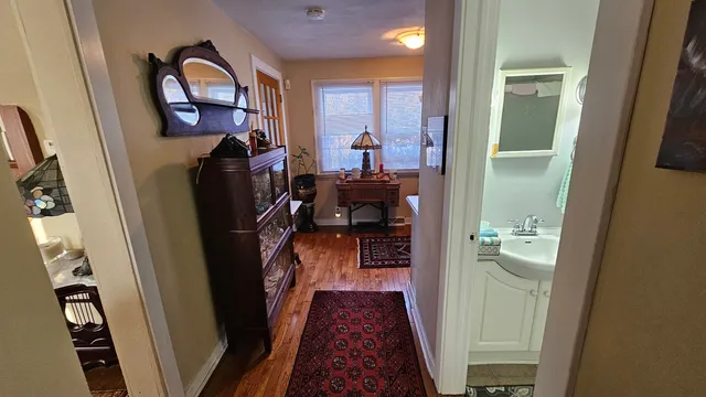 a view of a hallway with a livingroom and a fireplace