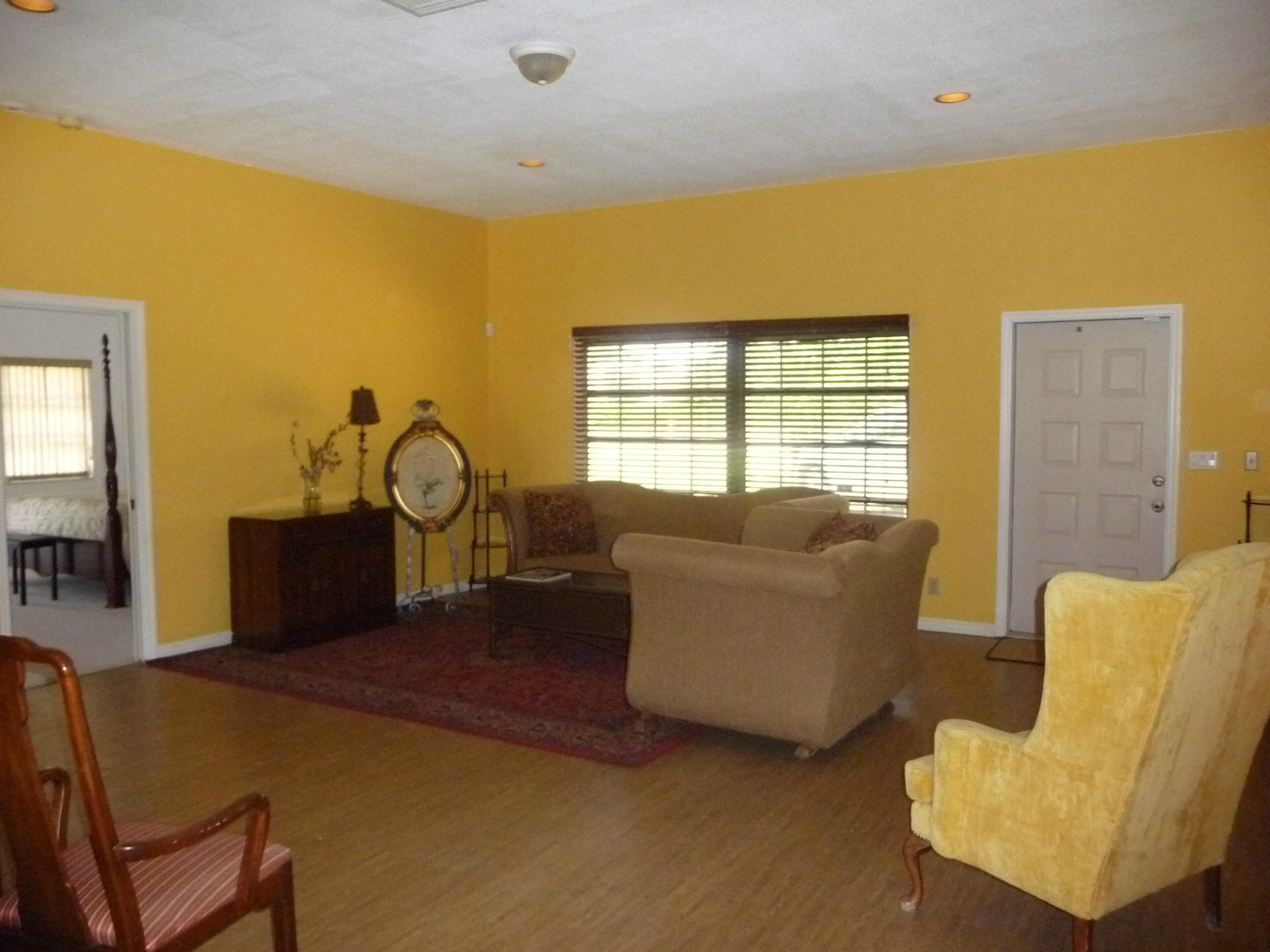 19655 118th Trail South, Unit FRNT Boca Raton, FL 33498 - Photo 22 of 31 a living room with couches chairs and a large window with outer view