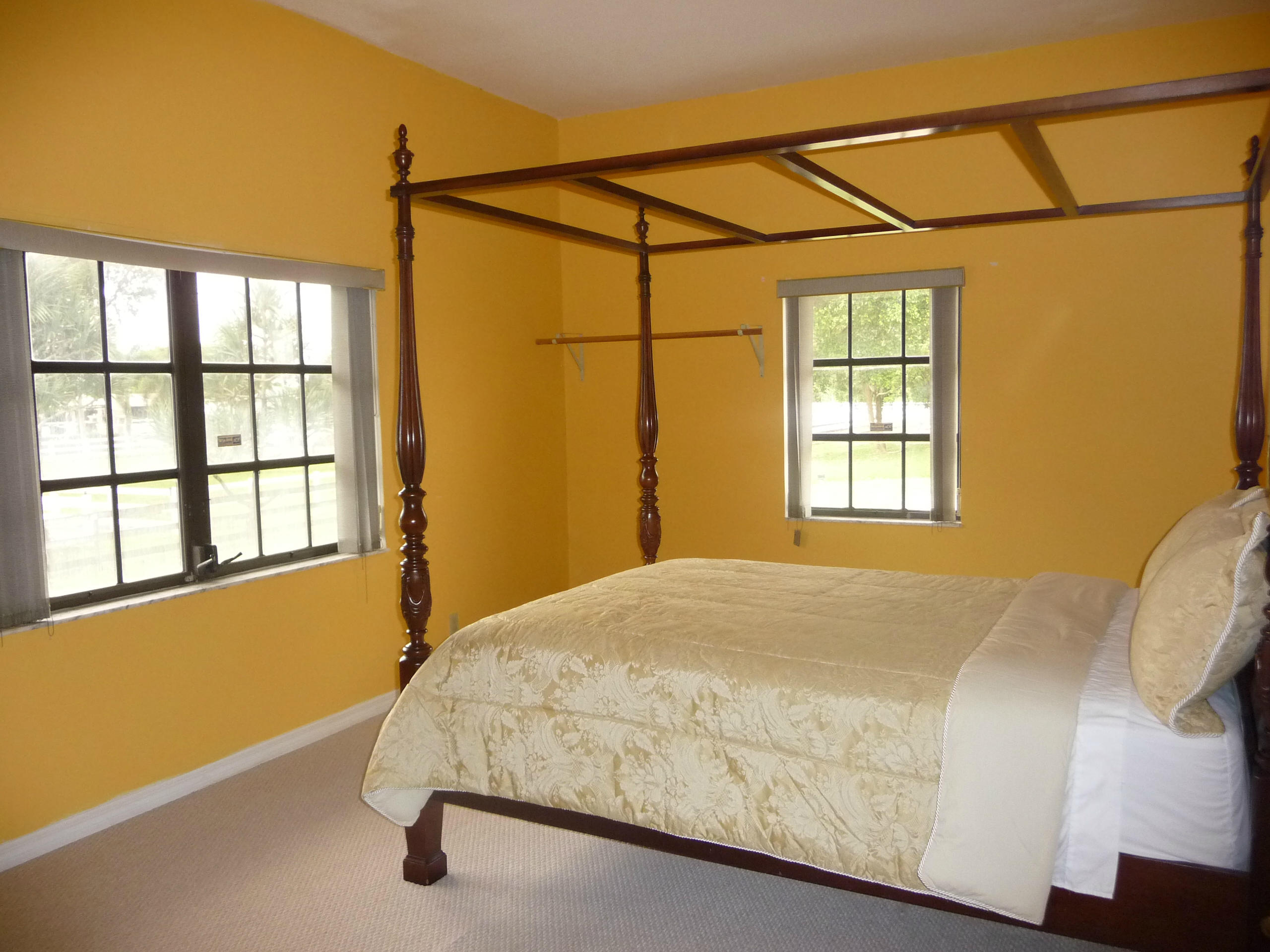 19655 118th Trail South, Unit FRNT Boca Raton, FL 33498 - Photo 26 of 31 a bedroom with a bed next to a window